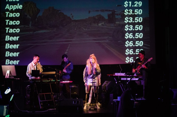 JaNae Contag as NAE sings Strip on stage at The Wilmette Theatre